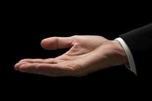 Open hand gesture in a business suit against a dark background, symbolizing opportunity photo