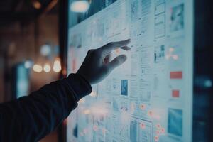 Person interacting with a digital display showcasing various documents in a modern workspace photo