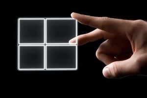 Hand interacting with a transparent touchscreen interface displaying four empty squares photo