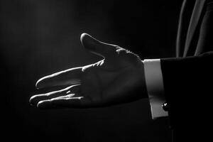 Elegant silhouette of a hand reaching out in a dramatic lighting setup, conveying invitation photo