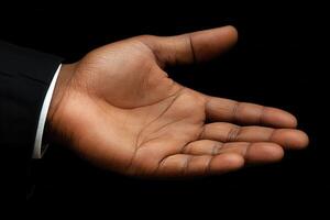 Open hand gesture against a black background, symbolizing offering or receiving help photo