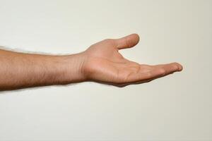 Outstretched hand on plain background, symbolizing openness and invitation photo