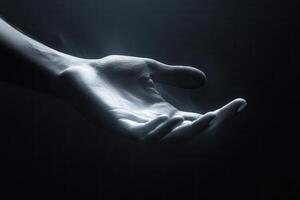 Ethereal hand reaching out in a dark space, symbolizing hope and connection photo