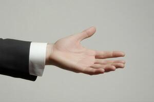 Outstretched hand in business attire against a neutral background, symbolizing offering or greeting photo