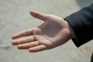 Open hand reaching out against a blurred background, symbolizing connection and opportunity photo