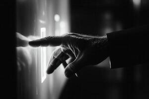 Hand pressing a glowing button on a sleek panel in a dimly lit modern environment photo