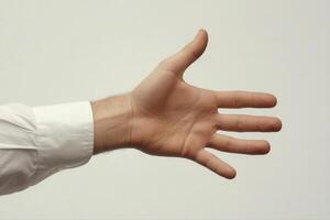 Outstretched hand in a formal shirt reaching forward against a neutral background photo