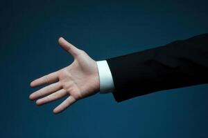 Outstretched hand in business attire against a blue background, symbolizing greeting or agreement photo
