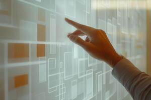 Hand interacting with a digital interface displaying abstract geometric patterns in a modern workspace photo