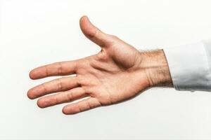 Open hand gesture against a plain background, symbolizing welcome or agreement photo