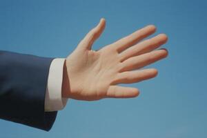Outstretched hand against a clear blue sky, symbolizing openness and communication photo