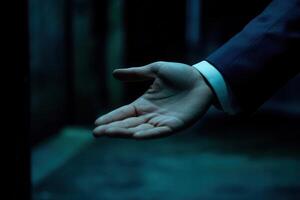 Outstretched hand in a dimly lit alley, symbolizing invitation or opportunity photo
