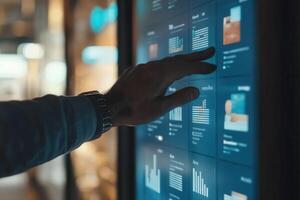 Person interacting with a digital display showcasing data visualizations in a modern setting photo
