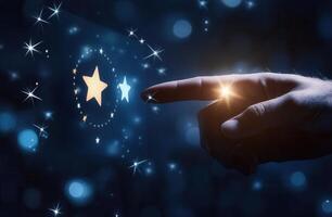 Hand reaching towards glowing stars in a dark, starry background, evoking a sense of wonder photo
