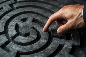 Hand navigating a complex maze design, symbolizing problem-solving and strategy photo