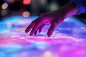 Interactive digital display with a hand reaching out, vibrant colors, modern technology setting photo