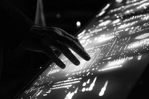 Human hand interacting with a digital touchscreen displaying data visualizations at night photo