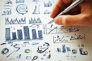 Hand sketching business graphs and charts on grid paper, illustrating data analysis concepts photo