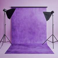 Studio setup with purple backdrop and lighting equipment ready for a photoshoot session photo