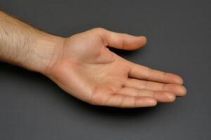Open hand gesture on a neutral background, symbolizing invitation or readiness photo