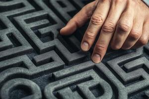 Hand navigating a textured maze, showcasing focus and problem-solving in a creative setting photo