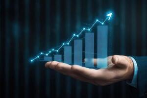 Hand presenting a digital bar graph with upward trend against a dark background photo