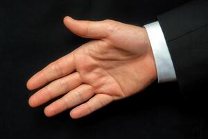 Open hand gesture in a professional setting, symbolizing greeting or agreement photo
