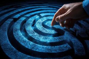 Hand reaching towards the center of a glowing blue maze, symbolizing problem-solving photo