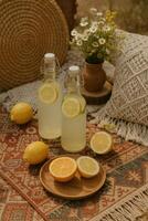 Two glass bottles of lemonade with lemon slices photo