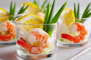 Shrimp appetizer with ice and green garnish photo