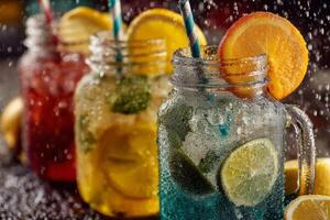 Refreshing sparkling beverages with lime and orange slices photo