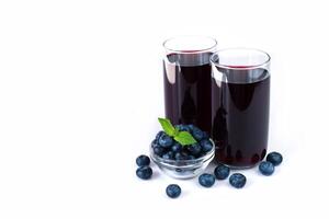 Two glasses of fresh natural blueberry juice isolated on white background. Place for text. photo