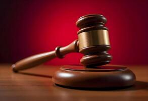 Judge Gavel on Wooden Block in Courtroom with Red Background photo