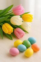 Colorful Easter Close Up With Spring Tulips and Easter Eggs on Table in Soft Natural Light for Holiday Decor photo
