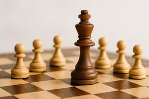Chess King and Pawns on Chessboard Depicting Strategic Concept in Soft Natural Light with Focus on Leadership and Competition photo