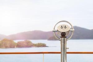 Binoculars on the deck view of the sea and islands photo