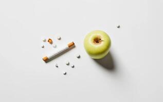 A green apple and a cigarette on a white background photo
