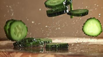 Sliced cucumbers fall on the table. Filmed on a high-speed camera at 1000 fps. High quality FullHD footage video