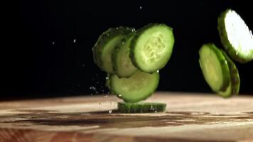Sliced cucumbers fall on the table. Filmed on a high-speed camera at 1000 fps. High quality FullHD footage video