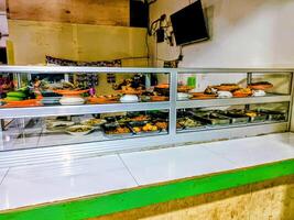 Display Case of Various Indonesian Dishes photo
