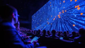 Audience watching interactive digital presentation during conference event photo