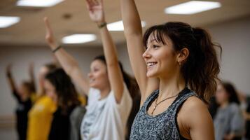 An enthusiastic dance class in progress where participants mirror the instructors movements filled with energy and expression under soft studio lights photo