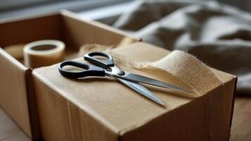A focused view of a pair of scissors ting through tape on a large shipping box highlighting the anticipation of what lies inside photo