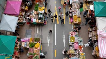 An aerial view of a bustling marketplace with various stalls each with unique signage and branding attracting customers with bright colors and engaging visuals photo