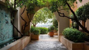 An ornate archway that welcomes visitors to a lush courtyard embellished with mosaic tiles and surrounded by lush greenery and tranquil water features photo