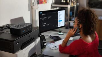 A techsavvy workspace showcasing a smarthome hub next to a computer setup with a user utilizing voice commands to activate a smart printer and a network of connected devices photo