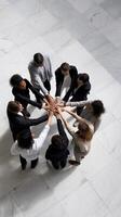Diverse business team united in circle. Hands clasped together, showing teamwork and collaboration photo