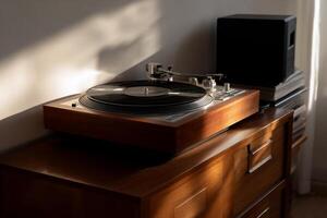 Wooden turntable bathed in sunlight on a wooden cabinet, beside a speaker and books photo