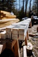 Stacked, light-colored wooden beams, ready for construction. Close-up view on a worksite photo