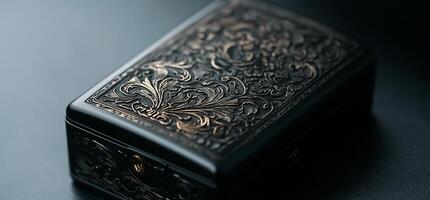 Ornate black box with intricate gold filigree design photo